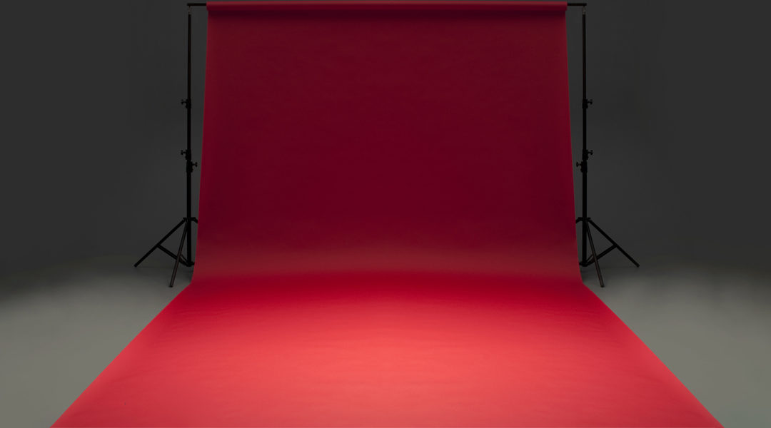 Seamless red background paper hanging on stands